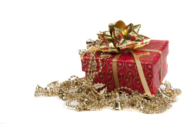 Red giftbox with golden bow and other new year's decoration Stock Image