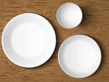 A set of white dishes on a wooden table clipart