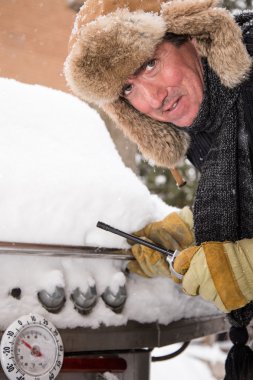 Unhappy Barbeque guy in Snow clipart