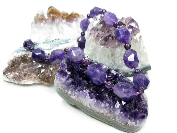 Amethyst geode geological crystals and jewelery beads — Stock Photo, Image