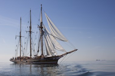 Schooner at sea in calm weather clipart