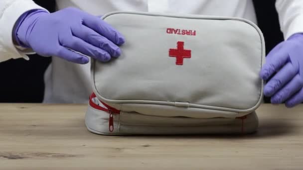 Close-up womans hands open the first aid kit with medicines and take out the necessary pills. — Stockvideo