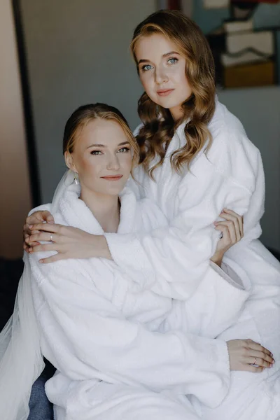 Young Beautiful Models Sitting Bed White Bathrobes Looking Camera High — Stock Photo, Image