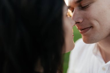 Genç sarışın, sevgi dolu bir kızın gözlerinin içine bakar ve gülümser. Kapatın. Yüksek kalite fotoğraf