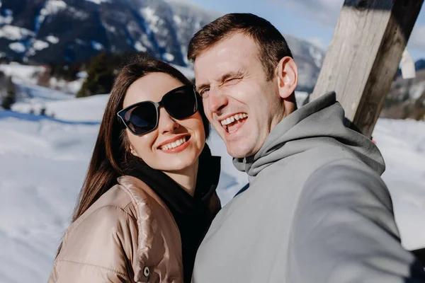 Loving Couple Stands Terrace Backdrop Snow Capped Mountains Smiles Close — 스톡 사진