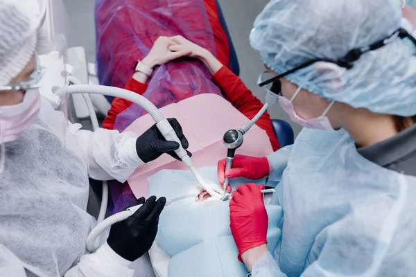 Female dentists treating a patient\'s teeth. Top view. Close-up. High quality photo