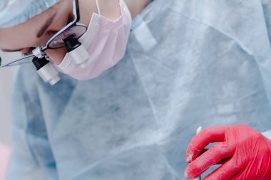  Woman dentist at work. Dentist shark with microscope close up. High quality photo
