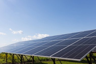  Solar panels on the background of a blue cloudy sky. Solar power plant. Blue solar panels. An alternative source of electricity. Solar farm in the field. High quality photo