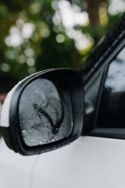 Side view of romantic heart pattern on fogged car side mirror. Vertycal photo. High quality photo