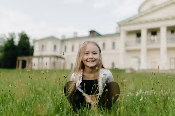 Cute European Little Girl Sitting Grass Smiling High Quality Photo — Stok fotoğraf