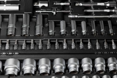 A large set of tools in a black box close-up. Nozzles of different sizes. High quality photo