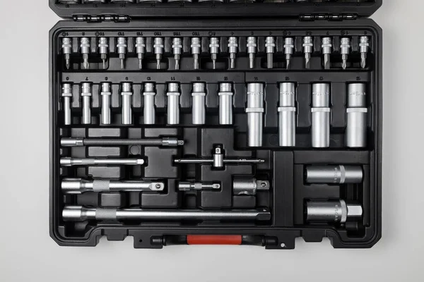  Wrenches of different sizes with different hex heads in a black box on a white table. View from above. High quality photo