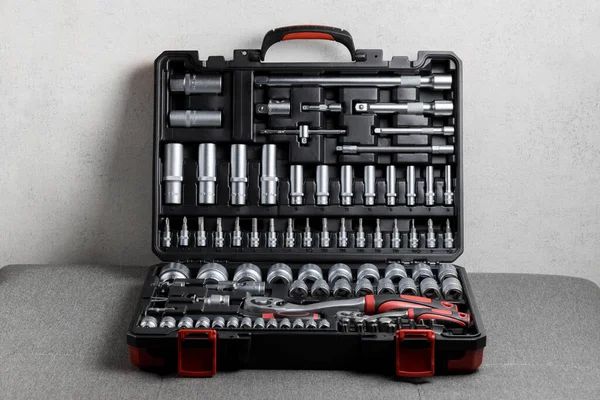 Tool box, details of a set of tools on a gray background. Tools. A set of tools. Car tool kit. Repair tools. High quality photo