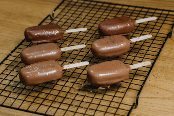 Ice cream cake with chocolate cream. Chocolate chip cookies on a stick in the form of ice cream on the table. High quality photo