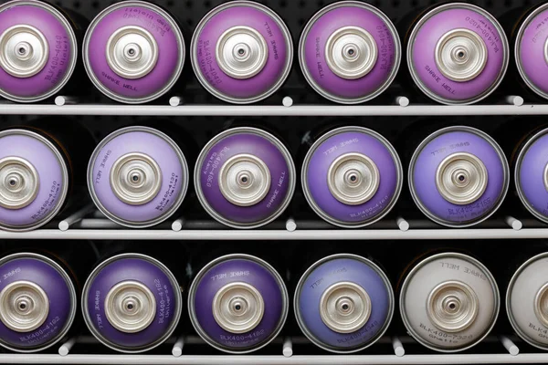 Cans with graffiti paints on the shelves. Paints for graffiti. Assortment of colors of tools for street art. High quality photo