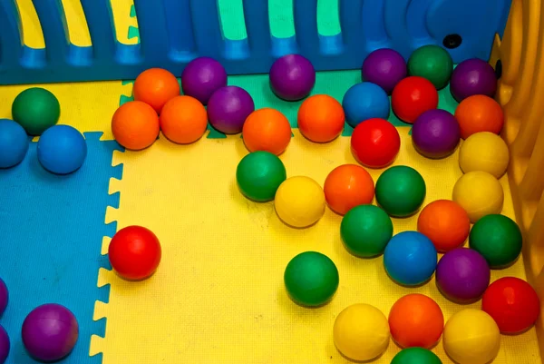 Plastic balls of different colors on the playground — Stock Photo, Image