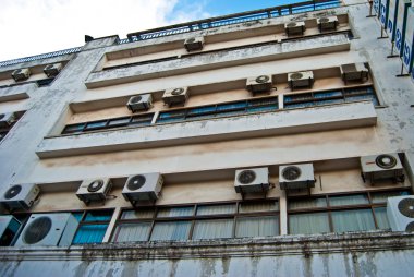 Wall of the building with outer blocks of air-conditioners clipart
