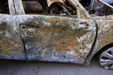 the doors of a burned-out car slashed by fragments from a jet fire system, after akaki of the racist troops on the peaceful thieves of ukraine