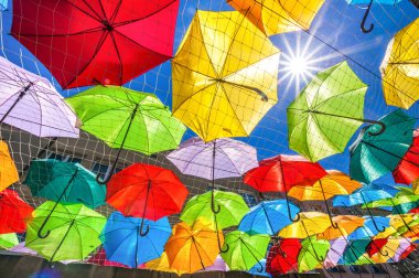Colorful umbrellas against the sky background