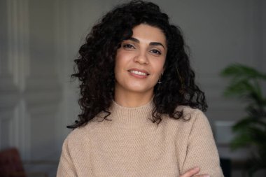 Temiz ciltli İspanyol bir kadının güzel portresi. Kıvırcık siyah saçlı, gülümseyen güzel kadın.