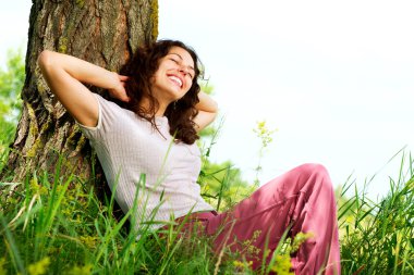 Beautiful Young Woman Relaxing outdoors. Nature clipart