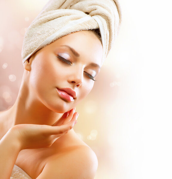 Spa Girl. Beautiful Young Woman After Bath Touching Her Face