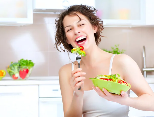 Dieta. Hermosa mujer joven comiendo ensalada de verduras Imagen De Stock