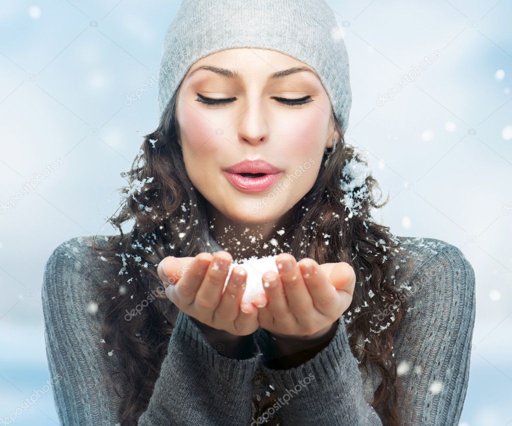 Christmas Girl. Winter woman Blowing Snow