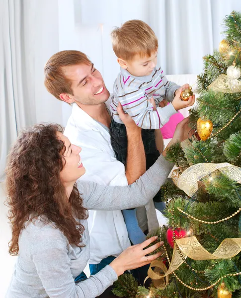 Young Family decorating a Christmas Tree Royalty Free Stock Images