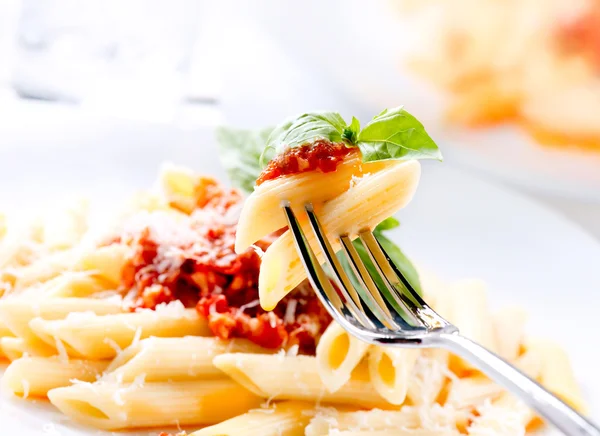 Těstoviny penne s omáčkou bolognese, bazalkou a parmazánem — Stock fotografie