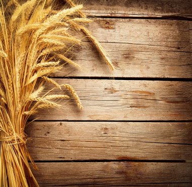 Wheat Ears on the Wooden Table. Harvest concept clipart