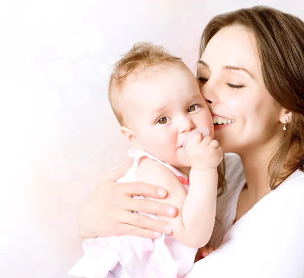 Mutter und Baby küssen und umarmen sich. Glückliche Familie — Stockfoto