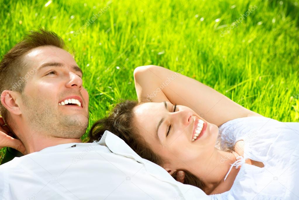 Young Couple Lying on Grass Outdoor