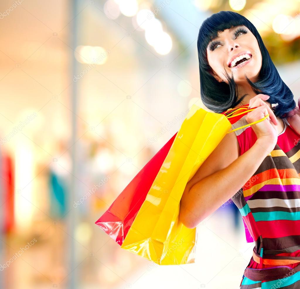 Beauty Woman with Shopping Bags in Shopping Mall