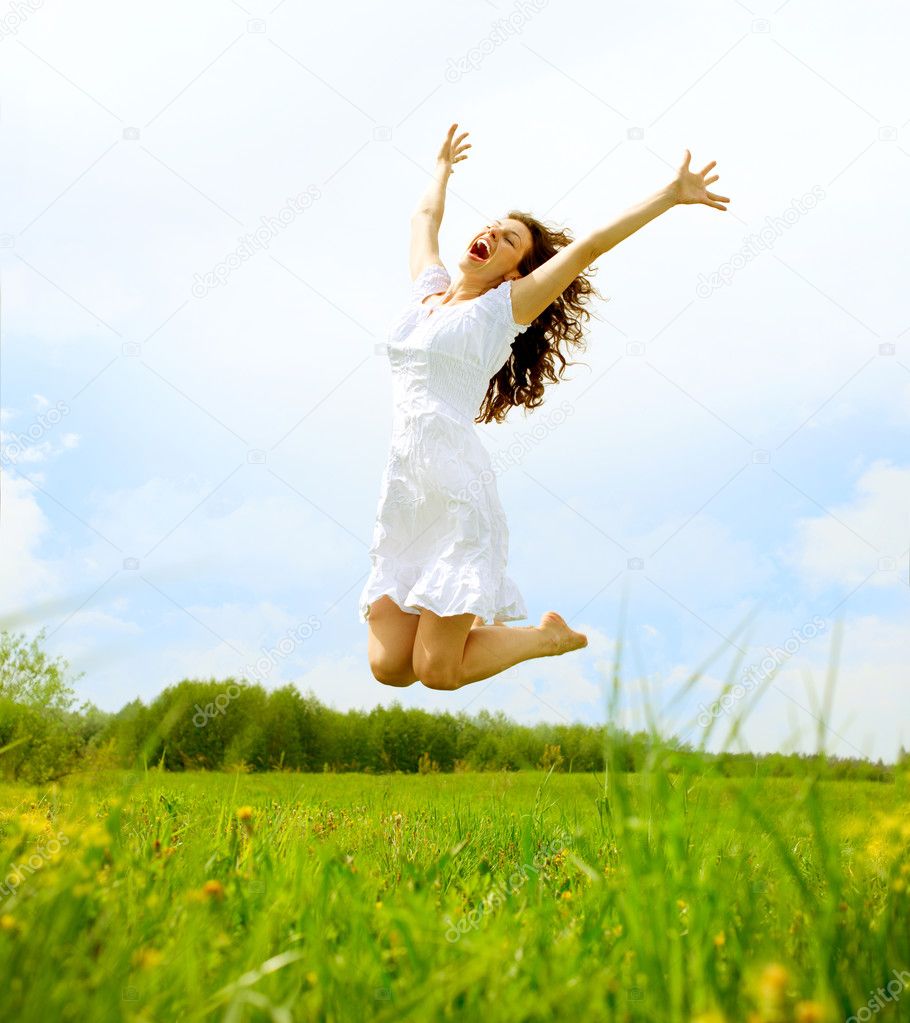 Happy Young Woman Jumping over blue sky. Beauty Girl Having Fun