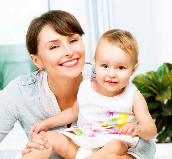 Moeder en baby zoenen en knuffelen thuis — Stockfoto