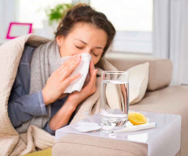 Sick Woman. Flu. Woman Caught Cold. Sneezing into Tissue