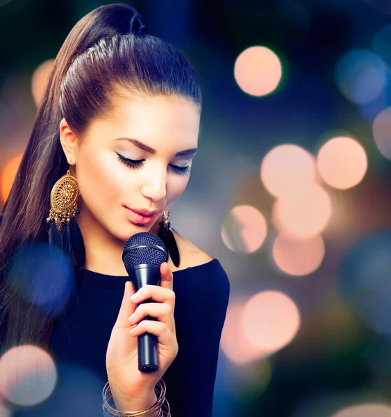 Mooi zingen meisje. schoonheid vrouw met microfoon — Stockfoto