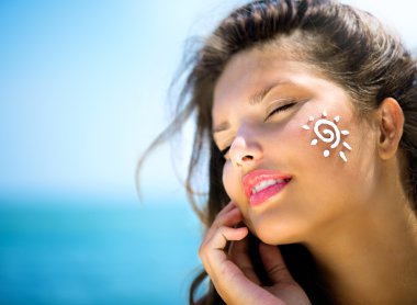 Girl Applying Sun Tan Cream clipart