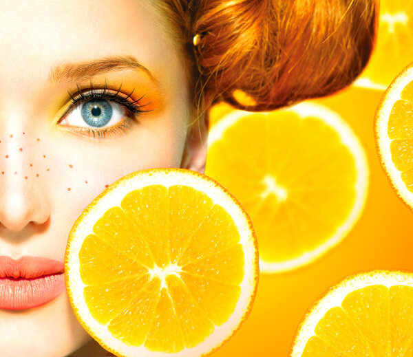 Model girl with juicy oranges.