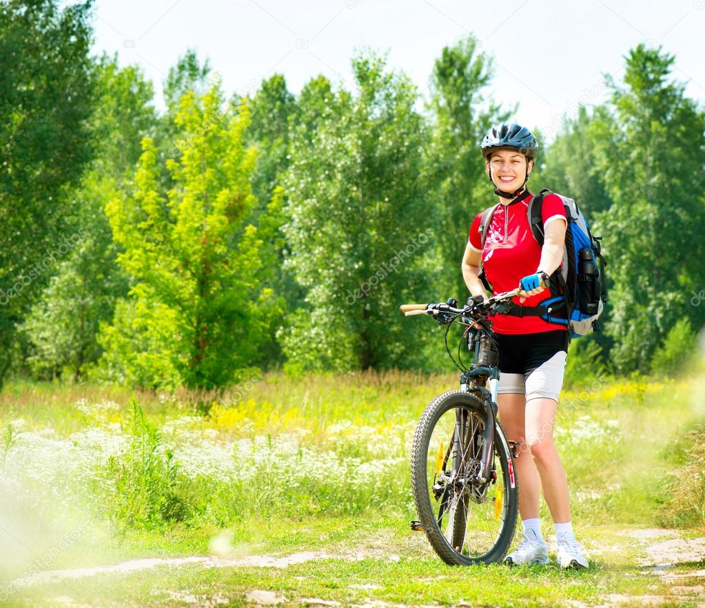 Young woman riding bicycle outside