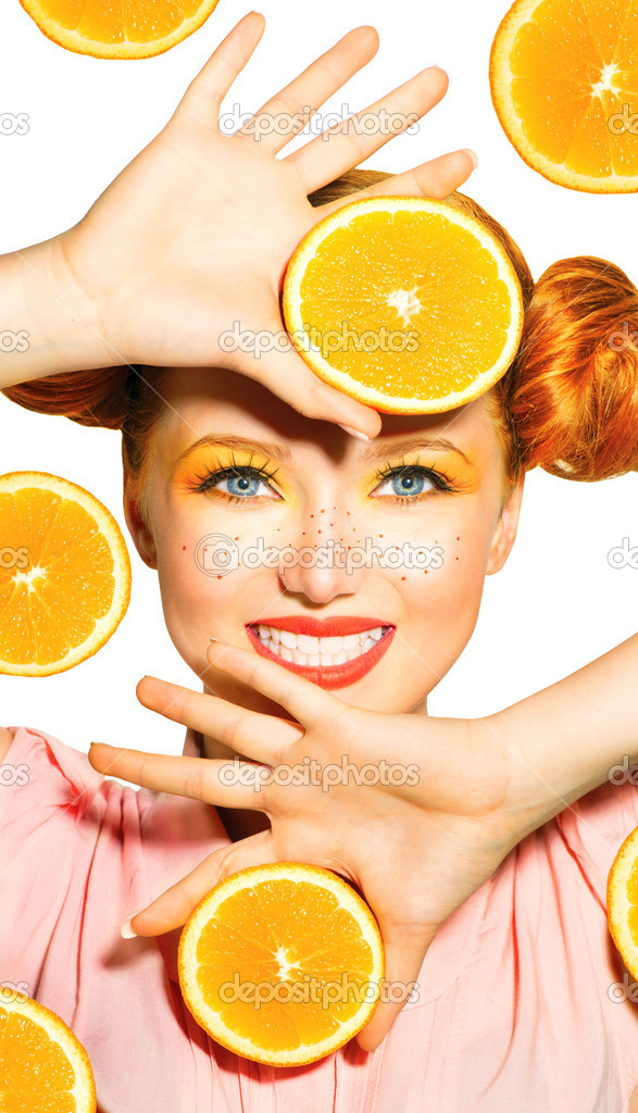 Model girl takes juicy oranges.