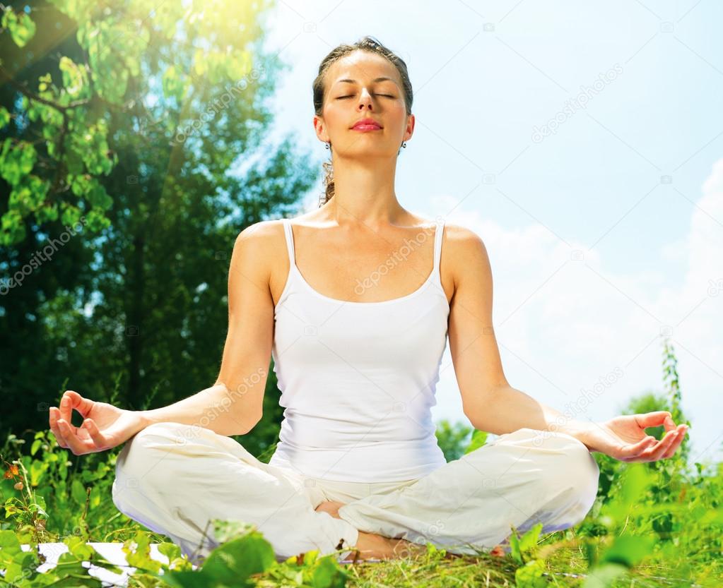 Young Woman doing Yoga Exercises