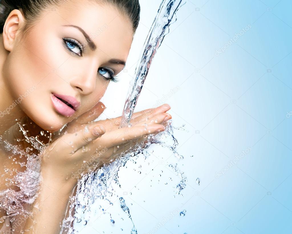 Model woman with splashes of water