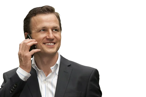 Businessman smiling while having conversation on mobile phone — Stock Photo, Image