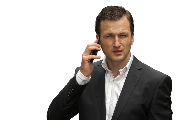Um homem com um telefone inteligente à mão. Isolado sobre um fundo branco Imagens De Bancos De Imagens Sem Royalties