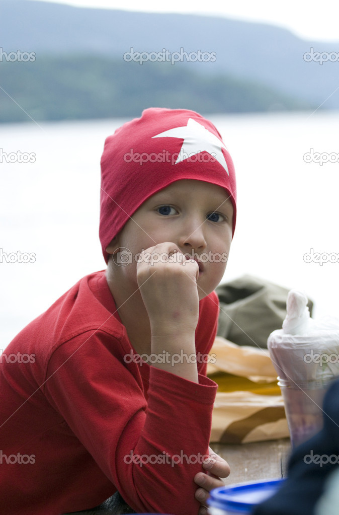 The boy in a red cap with a star