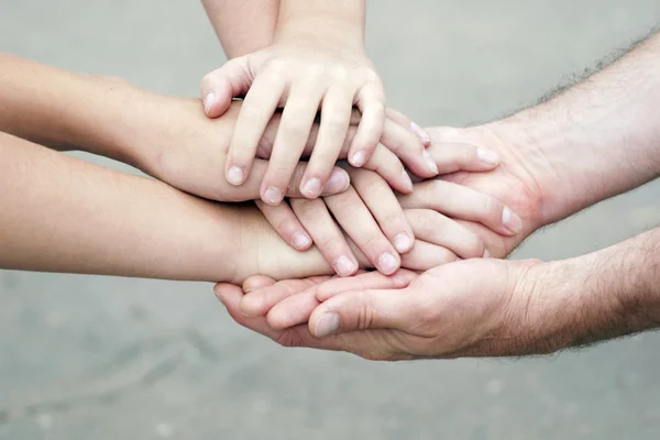 Many hands lying on top of each other — Stock Photo, Image