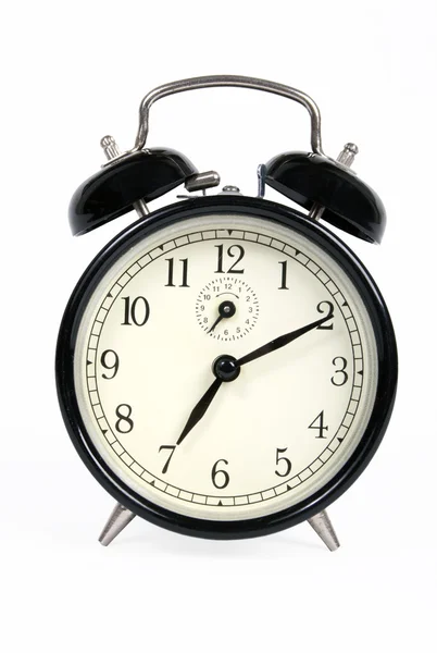 A classic old black alarm clock on white background Stock Image