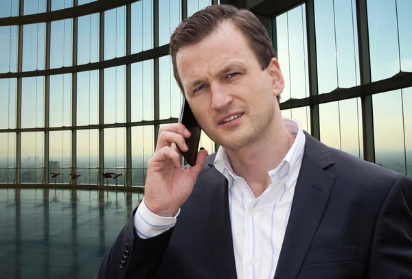 Businessman having conversation on mobile phone — Stock Photo, Image